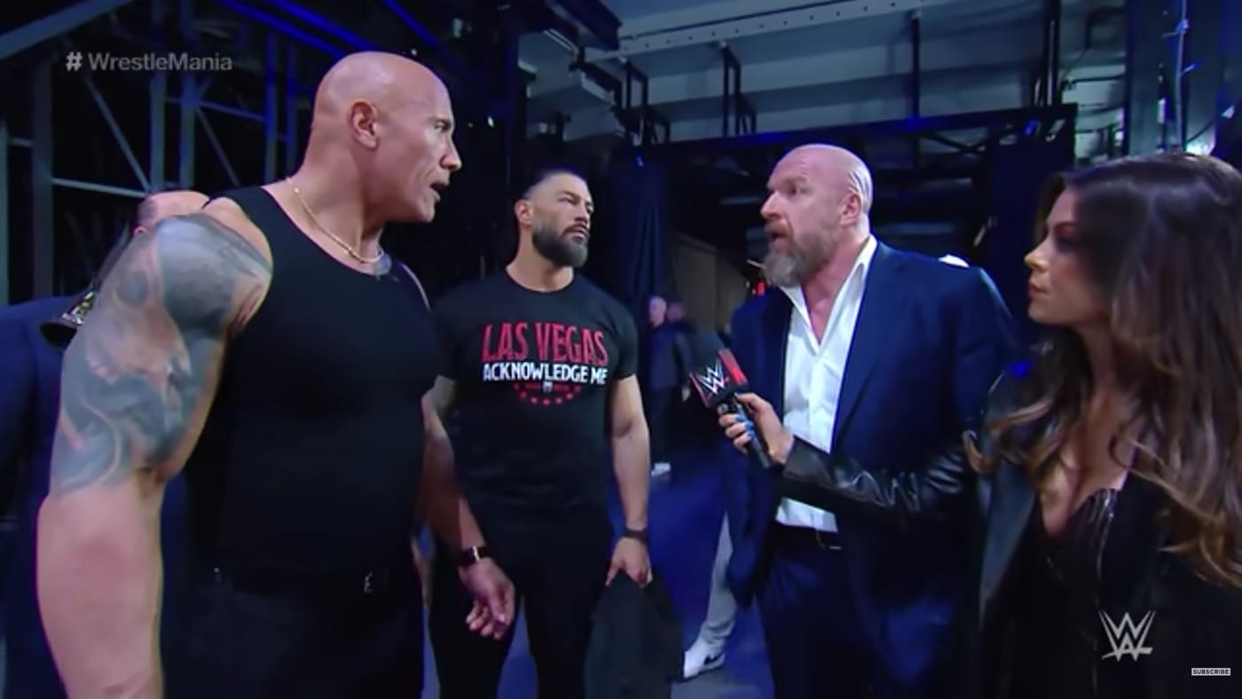 Jackie Redmond with Triple H and The Rock. Photo: WWE